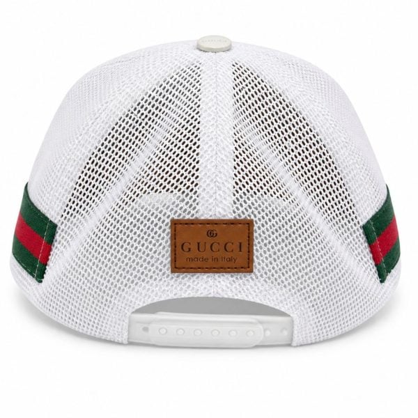 Back view of a white Gucci mesh baseball cap with a brown leather label and green-red webbing straps, adjustable snap closure at the rear.