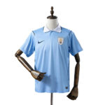 Light blue Uruguay national team soccer jersey on a mannequin, featuring a white collar, Nike swoosh, and crest with stars on the left chest