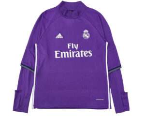 Purple Real Madrid goalkeeper jersey with Adidas logo, crest, and 'Fly Emirates' sponsor text on the front, long sleeves with cuff details