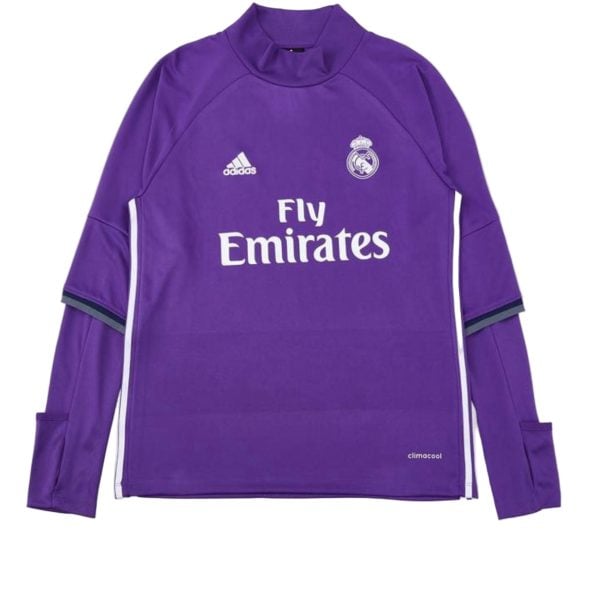 Purple Real Madrid goalkeeper jersey with Adidas logo, crest, and 'Fly Emirates' sponsor text on the front, long sleeves with cuff details