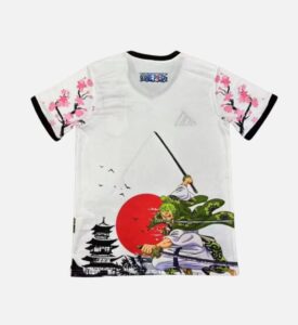 White T‑shirt with anime samurai artwork, red sun, and cherry blossom sleeves; includes a One Piece logo on the collar tag and pagoda silhouettes at the bottom.