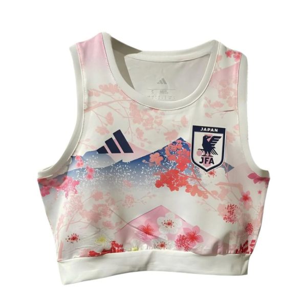 White sleeveless athletic top with pink floral pattern and a Japan Football Association badge on the chest, Adidas logo nearby.