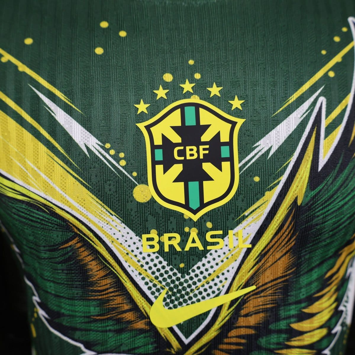 Close-up of the Brazil national football team crest on a green jersey with yellow accents.