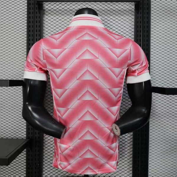 Mannequin wearing a pink geometric-pattern polo shirt displayed in a store window