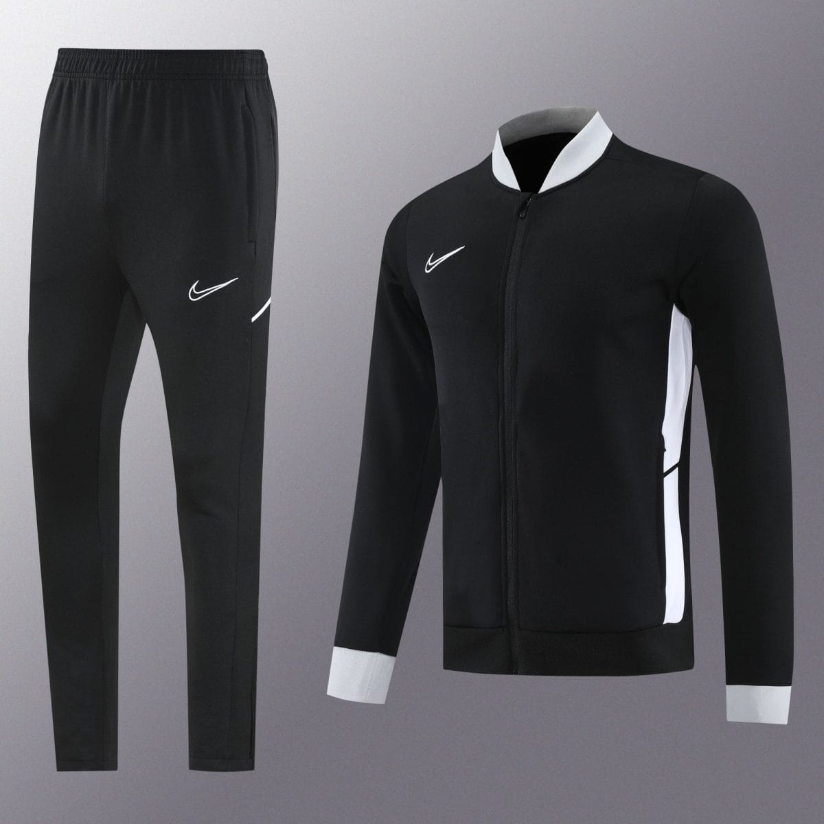 Black athletic tracksuit (pants and zip-up jacket) with white Nike swoosh logos and white side panels on the jacket.