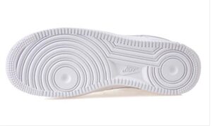 White Nike sneaker sole viewed from the bottom, showing circular tread patterns and a small Nike logo near the midfoot