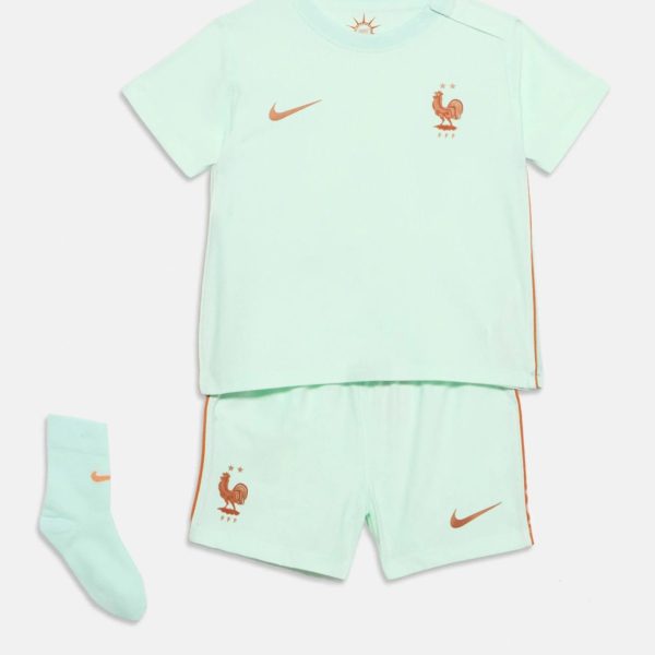 Mint green soccer jersey with orange Nike swoosh and French rooster crest, paired with matching shorts and socks