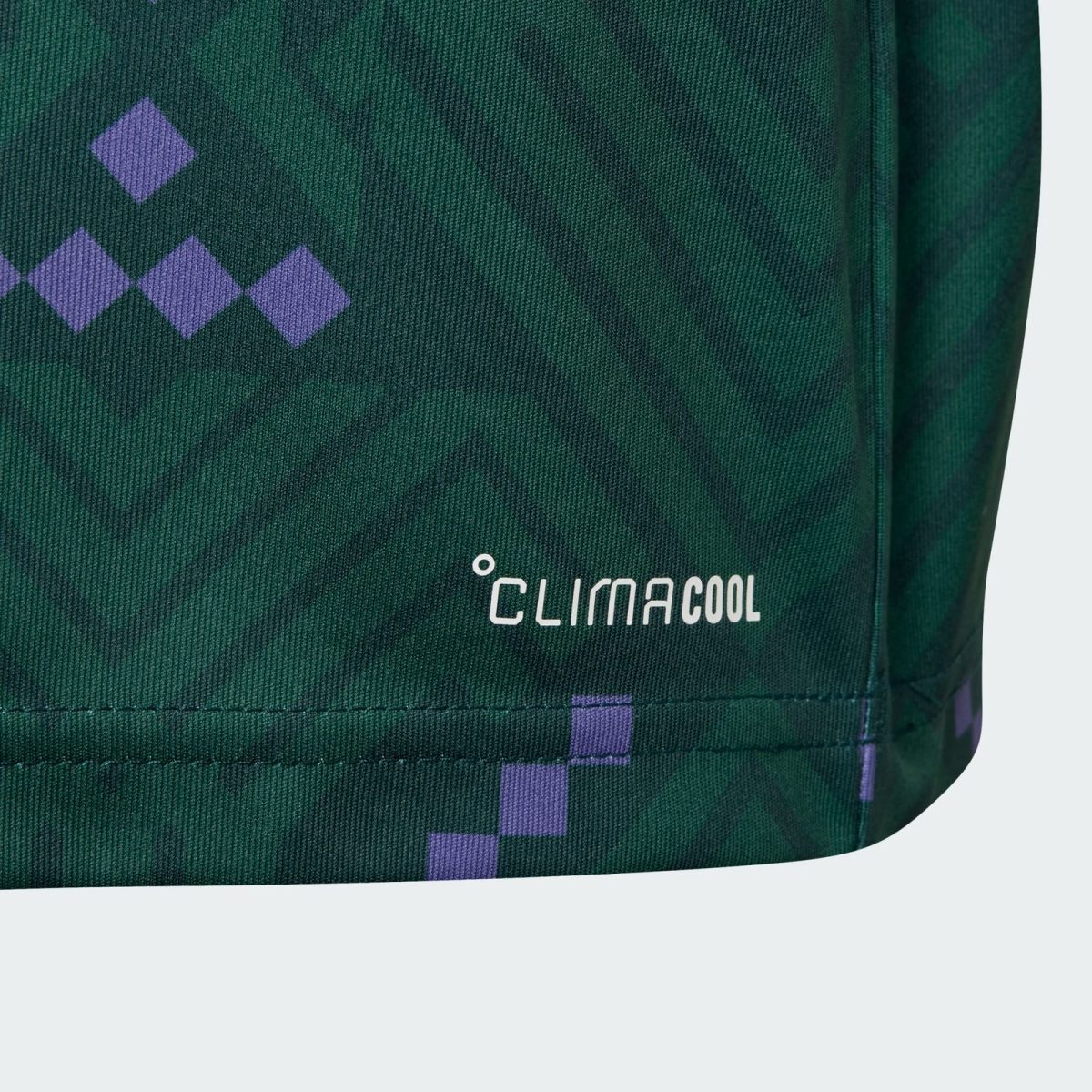 Close-up of dark green fabric with a purple diamond pattern and the white 'ClimaCool' branding visible on the seam area.