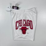 White Chicago Bulls basketball jersey featuring red and black 'CHICAGO' lettering and Bulls logo, with NBA tag visible.