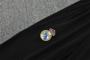 Black blazer with a Real Madrid club crest patch sewn on the chest area.