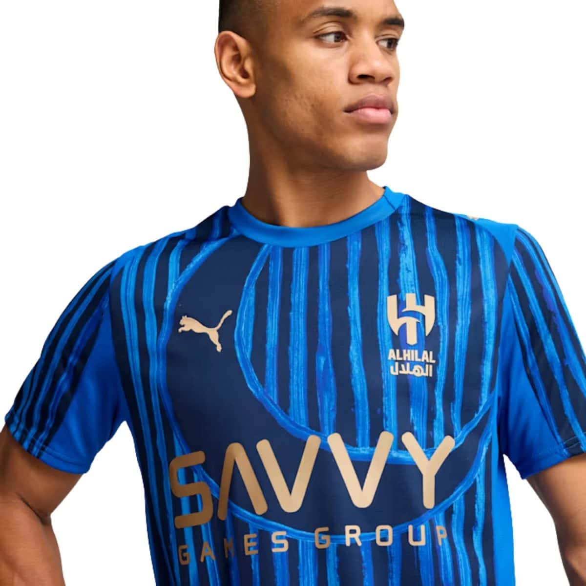 Young man in a blue striped soccer jersey with the Puma logo and Al Hilal crest on the chest.