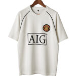 White T-shirt on a hanger featuring a boxed AIG logo and a circular embroidered patch on the chest left side.