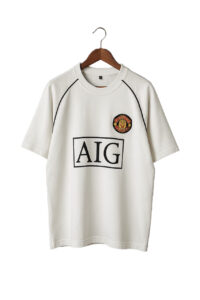 White T-shirt on a hanger featuring a boxed AIG logo and a circular embroidered patch on the chest left side.