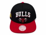 Black Chicago Bulls baseball cap with a red brim and bold white 'BULLS' embroidery on the front, featuring the team logo beneath.