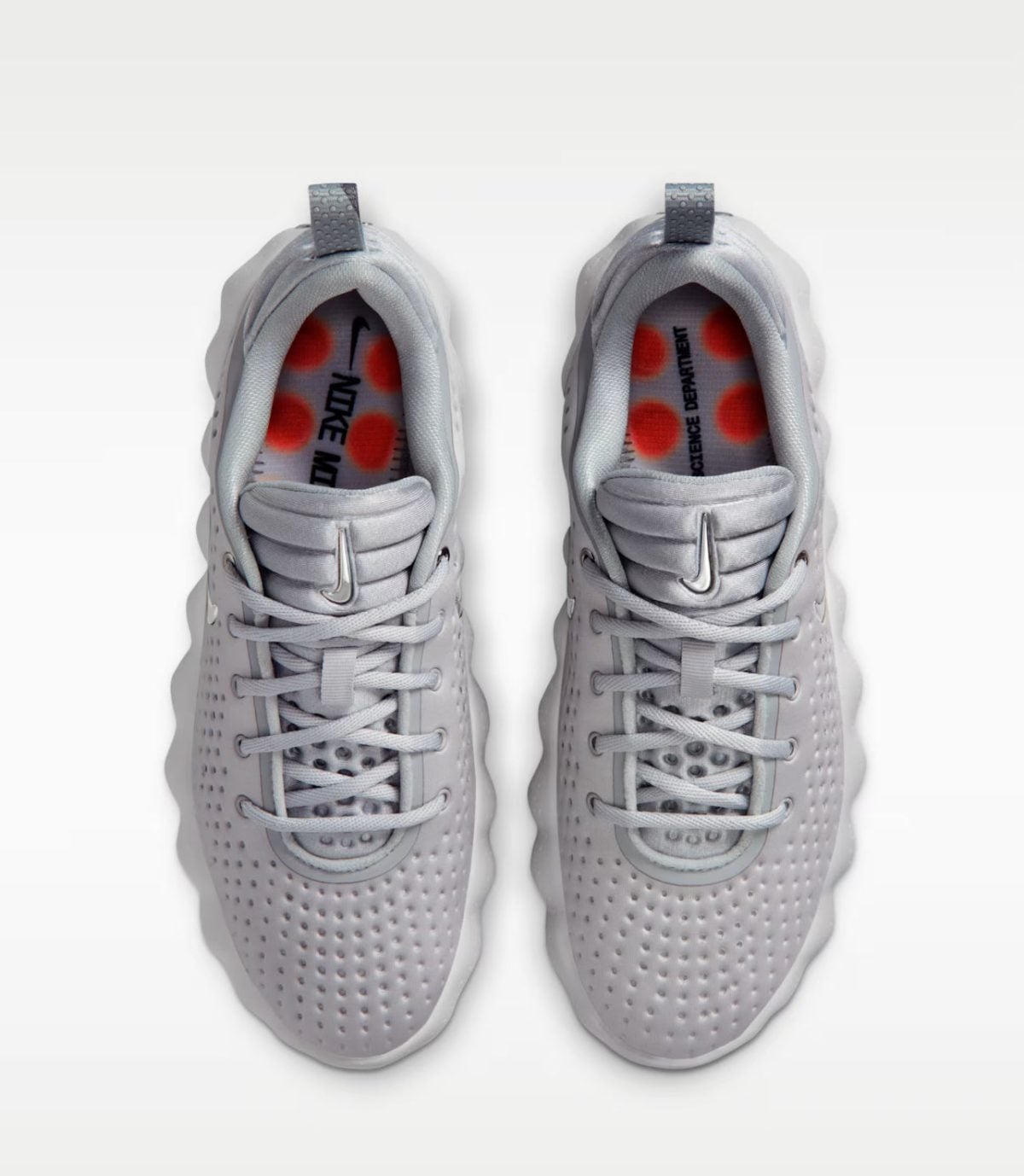 Top-down view of two light-gray athletic sneakers with perforated uppers and pull tabs, placed side by side against a white background.
