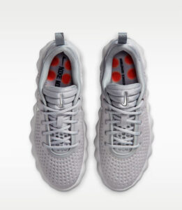 Top-down view of two light-gray athletic sneakers with perforated uppers and pull tabs, placed side by side against a white background.