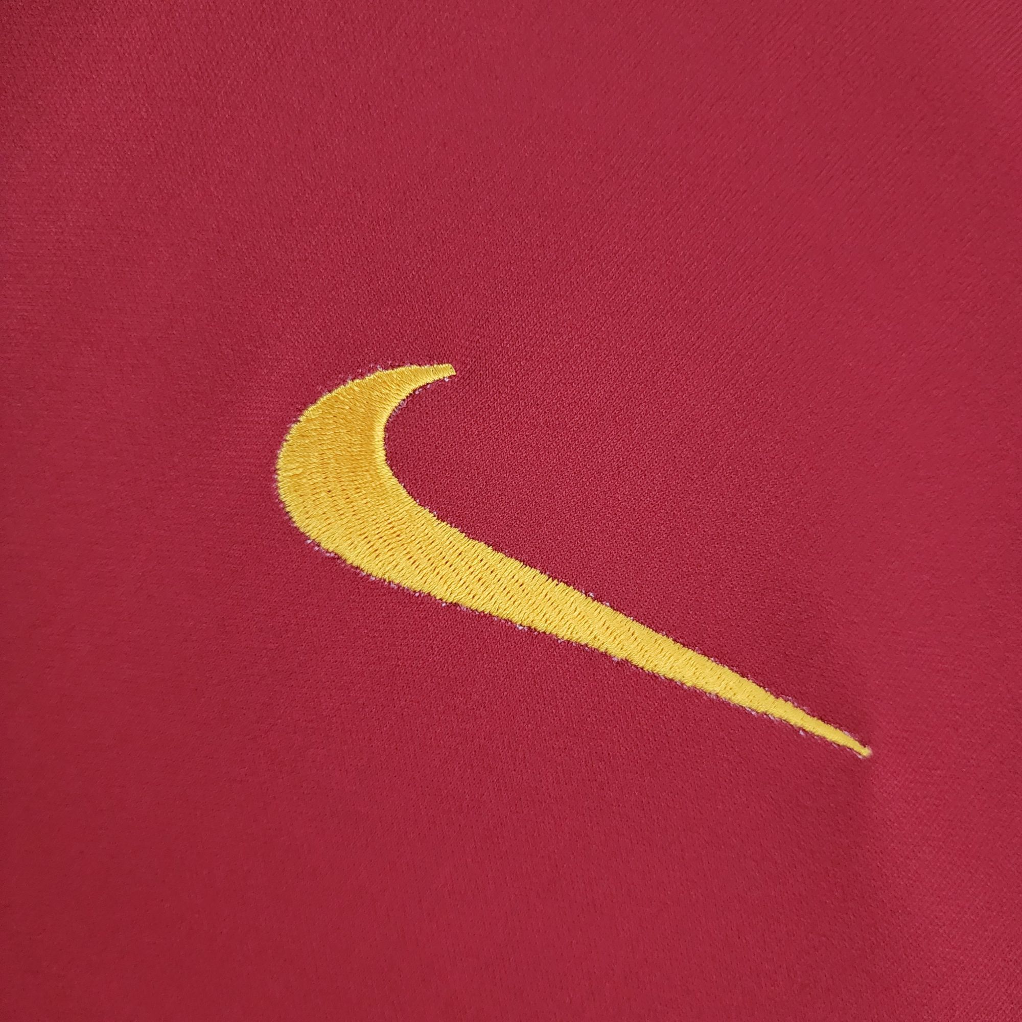 338ce696_d3627b46-b2eb-4c4b-ba5e-7961bdfa3a43 | UAE SPORT STORE Close-up of red fabric with a yellow embroidered crescent.