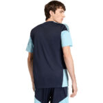 Man wearing a color-block navy and light-blue athletic jersey, viewed from the back.