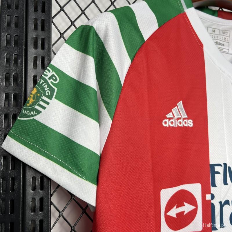 34337bbbca54b883 | UAE SPORT STORE Close-up of a green-and-white striped sports jersey with a red panel and Adidas logo, hanging on a metal rack.