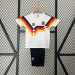 3541a1e8 | UAE SPORT STORE White Adidas Germany national team jersey on a wooden hanger, featuring black, red, and gold chevron stripes against a wire mesh backdrop.