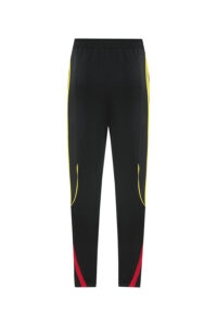 Black athletic jogger pants with yellow side stripes and red cuffs at the ankles.
