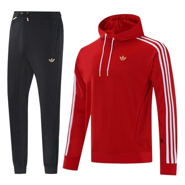 Red Adidas track hoodie with white stripes on the sleeves and white drawstrings, shown with matching black joggers.