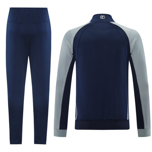 Navy blue tracksuit with light gray raglan sleeves: jacket and matching navy pants.