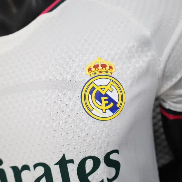 Close-up of Real Madrid club crest on a white jersey.