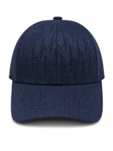 Navy blue baseball cap with embossed 'Christian Dior COUTURE' logo on the front panel, structured crown and curved brim