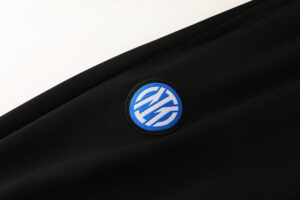 38e89216 | UAE SPORT STORE Close-up of a blue circular HP logo patch sewn onto black fabric.