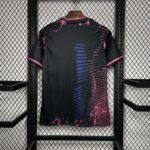 Black T-shirt with pink neon cracks and blue curved lines, hanging on a hanger in a metal display rack.
