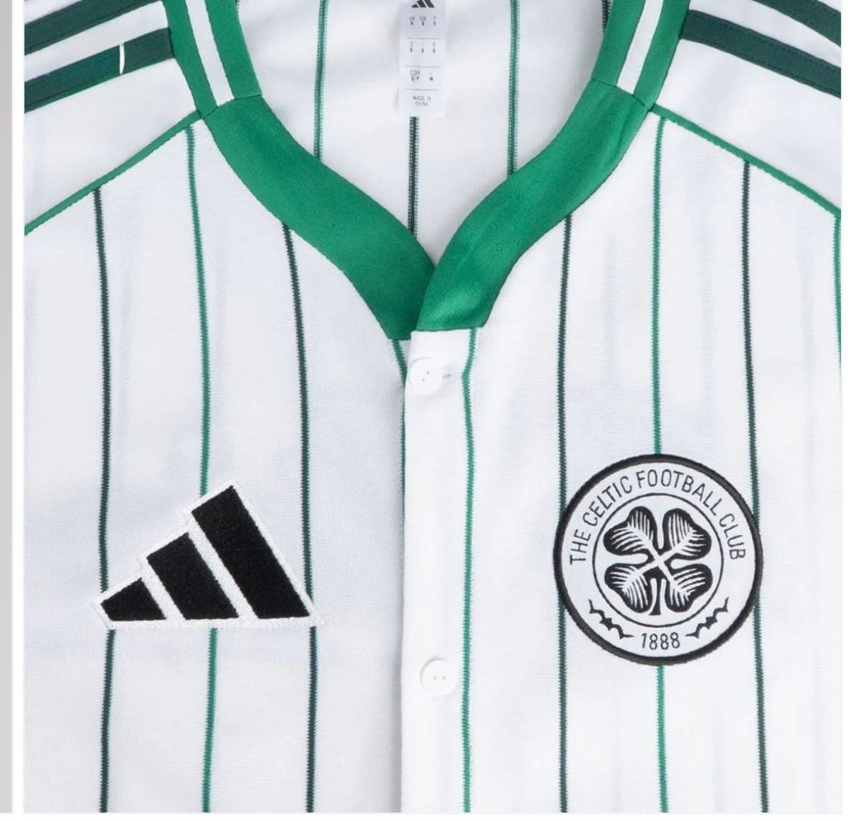 Close-up image of a white striped Celtic football jersey with green accents, showing the Adidas logo and Celtic FC crest on the chest area.