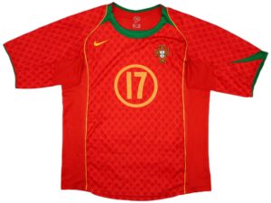 Portugal national football jersey in red with a green collar and yellow trim, featuring a crest on the left chest and a large yellow 10 on the front.