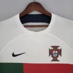 White sports jersey on a wooden hanger, showing a black Nike swoosh and the FPF Portugal crest.