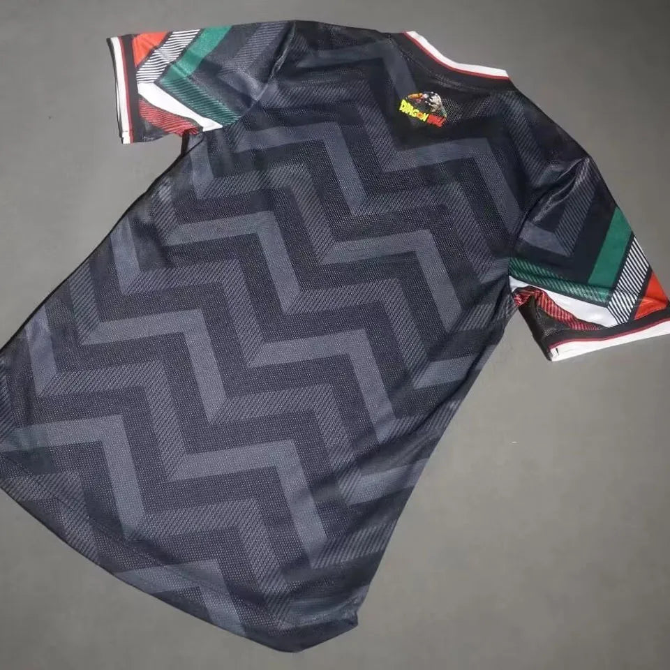 3a54eb63598e86a4 | UAE SPORT STORE Dark athletic jersey with a large zigzag pattern and multicolor striped sleeves laid flat on a gray surface.