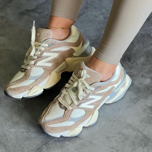Beige and cream chunky sneakers worn with light beige leggings, laces tied, showing the New Balance