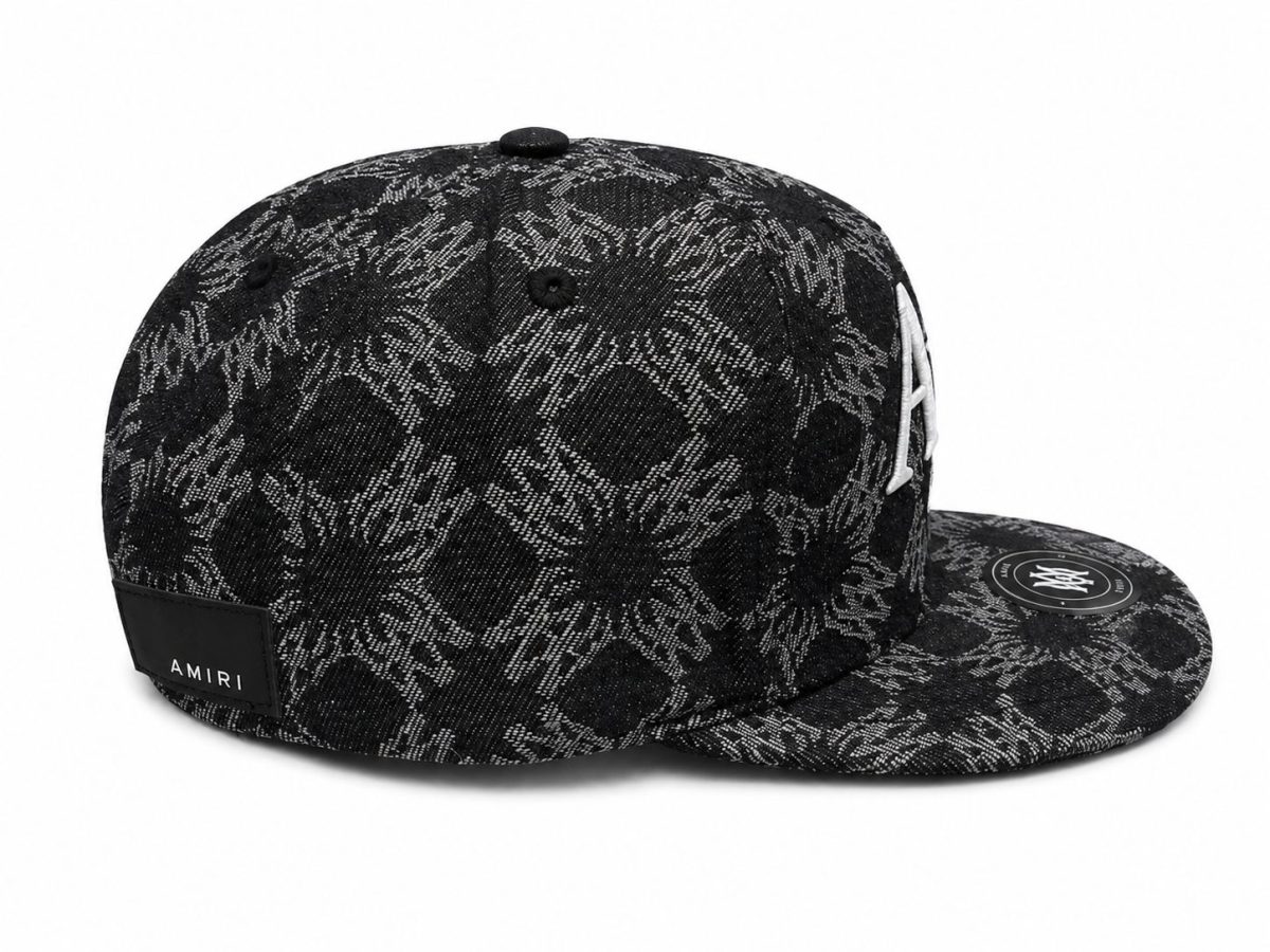 Black snakeskin-pattern baseball cap with AMIRI label at the back and a flat brim edge.
