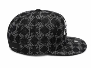 3b77682c-9281-4d63-b8a6-b39032c41546 | UAE SPORT STORE Black snakeskin-pattern baseball cap with AMIRI label at the back and a flat brim edge.