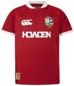 Red rugby jersey with white collar and sleeve cuffs, featuring a team crest on the left chest and the word HOWDEN in bold white across the front.