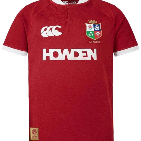 Red rugby jersey with white collar and sleeve cuffs, featuring a team crest on the left chest and the word HOWDEN in bold white across the front.