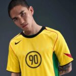 Young man in a yellow sports jersey with the number 90, facing the camera.