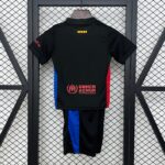 Back view of a black athletic jersey hanging on a wooden hanger, with blue and red side panels and the UNHCR logo and text near the bottom main back area, against a metal grid backdrop with a small yellow-red striped patch at the upper center.