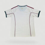 3c8ac4c9-bf76-4961-b479-02fc2d9a4917-1000x1000-iMXVLdgoI8ABu1yQvzch6MTxZ0Dvhi2a1C8GLa3P | UAE SPORT STORE White athletic jersey with burgundy piping and teal sleeve cuffs laid flat against a light background.