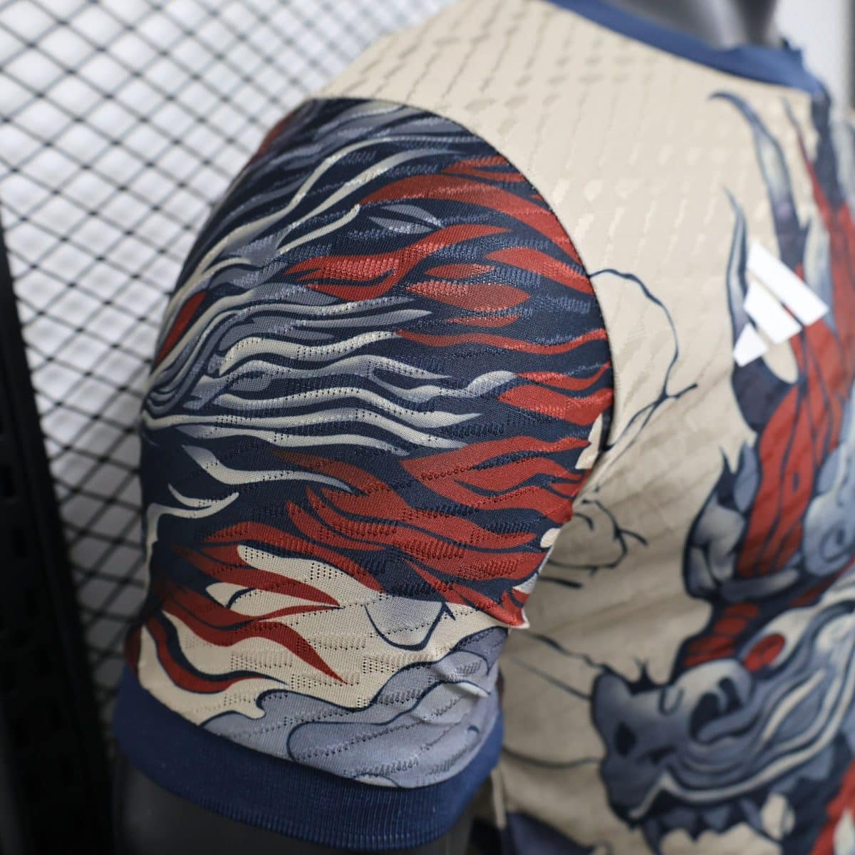 Close-up of blue, red, and beige wavy patterned fabric upholstery on a seat.