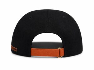 Back view of a black cap with an orange adjustable strap and gold buckle.