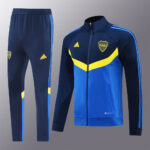 3d8f2f1e | UAE SPORT STORE Blue Adidas tracksuit set: navy jacket with blue and yellow color blocking, matching navy pants with light blue stripes, CABJ crest and Adidas logo visible.