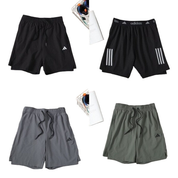 Four Adidas athletic shorts (black, black with side stripes, gray, and olive green) laid out with drawstrings and small logo visible on each pair.