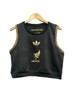 Product photo: black sleeveless crop top with gold trim on the armholes and gold México emblems on the front (including the eagle crest and 'MÉXICO' text).