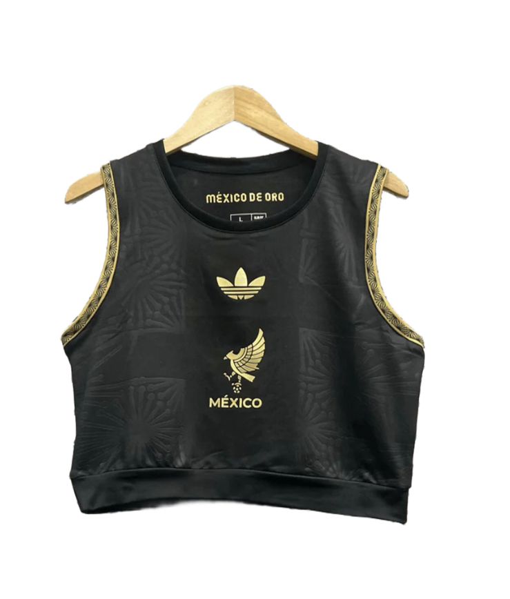 3e9e470b-0757-4f3e-b22d-b12062d7c02e Product photo: black sleeveless crop top with gold trim on the armholes and gold Mรฉxico emblems on the front (including the eagle crest and 'MรXICO' text).