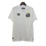 White soccer jersey on a hanger, featuring a blue-patterned collar, Umbro logo on the left chest, and a black-and-white shield crest with three yellow stars above it.